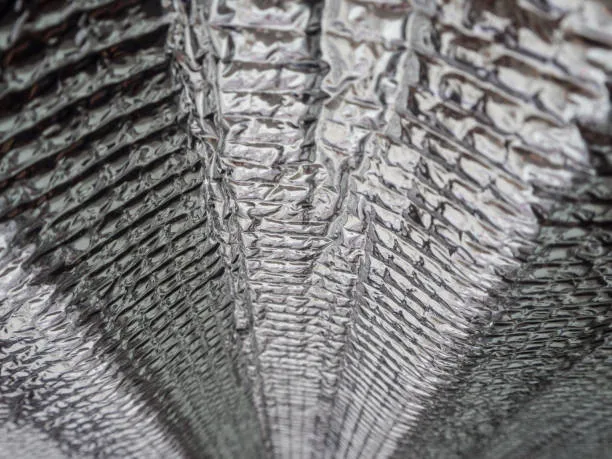 Reflective radiant barrier installed beneath a sloped roof